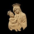 Virgin Mary with Jesus Christ. Fragment of an ancient statue isolated on black backgrouund
