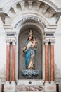 Virgin Mary with blessing Son Jesus on blue cloud in marble side niche of Cathedral Santa Marta, Colombia, Caribbean Sea