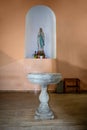 Virgin Mary statue and marble water bowl in St Stephen`s Catholic Church in Shkodra. Catholic Royalty Free Stock Photo