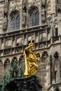 Virgin Mary statue at Marienplatz square, Munich, Germany. Golden sculpture atop Mariensaule column Royalty Free Stock Photo