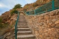 Virgin nature. Outdoor. Landscape. Stone staircase. Old long stairs with handrail. Rocky terrain. Stunning hidden place