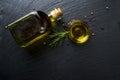 Virgin olive oil in a glass bottle and rosemary