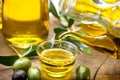 Virgin olive oil pouring in a bowl closeup