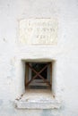 Virgin of the Snow ancient church on mountain top, small window for charity in Prato Nevoso, Italy