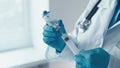 A virologist, holding a syringe for injection, vaccinates to help stop the spread of infectious diseases. A pharmacist