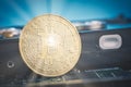 Golden bitcoin on dismantle hard disk over gently lit dark background and light ray Royalty Free Stock Photo