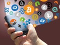 Virtual cryptocurrency - financial technology and internet money - smartphone in a hand and coin signs
