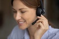 Young woman call centre manager in headset taking client call