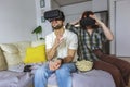 Couple in casual clothes wear the virtual reality glasses are watching and showing imagine via the VR camera