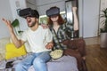 Couple in casual clothes wear the virtual reality glasses are watching and showing imagine via the VR camera