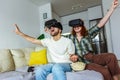 Couple in casual clothes wear the virtual reality glasses are watching and showing imagine via the VR camera