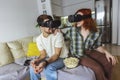 Couple in casual clothes wear the virtual reality glasses are watching and showing imagine via the VR camera