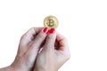 Virtual money golden bitcoin women hand with red nails fingers isolated on white background Royalty Free Stock Photo