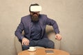 Virtual office and work space. Businessman sit chair wear hmd explore virtual reality or ar. Business partner interact