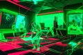 Virtual Reality Bar with Chaotic Green Neon Light Geometric Traces and Dancing Silhouettes, Generative AI