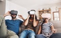 Virtual reality fun for all ages. a young family using virtual reality headsets together at home. Royalty Free Stock Photo