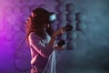 Virtual reality game. A girl in a virtual reality helmet plays a game or explores the environment.