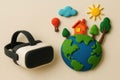 Virtual reality glasses and a planet with a house and trees made of plasticine. Royalty Free Stock Photo