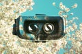 Virtual reality glasses, superimposed on trees pink flowers in s