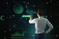 Virtual reality and innovation concept with man back view pushing button on dark green digital touch screen with technological Royalty Free Stock Photo