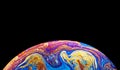 Virtual reality space with abstract multicolor psychedelic planet. Closeup Soap bubble like an alien planet on black background Royalty Free Stock Photo