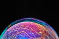 Virtual reality space with abstract multicolor psychedelic planet. Closeup Soap bubble like an alien planet on black Royalty Free Stock Photo