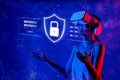Virtual Reality User Engaged in Cybersecurity Practices with Lock and Data Elements Surrounded by a Futuristic Neon Royalty Free Stock Photo