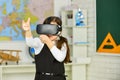 Virtual work. In a Computer Science Class. Works on a Programing Project. vr technology. schoolchild using virtual Royalty Free Stock Photo