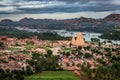 Virupaksha temple with bright dramatic sky and rocky mountain background at morning from hill top Royalty Free Stock Photo