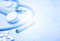 Virus Coronavirus blood test, pills, syringe and stethoscope on blue copy space background for a banner. Blue filter