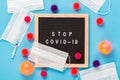 Virus COVID-19 protection concept. Virus abstract models with medical masks, syringe and letterboard with words Stop COVID-19 on