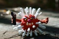 Virus figurine made of plasticine with a toy gun