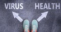 Virus and health as different choices in life - pictured as words Virus, health on a road to symbolize making decision and picking