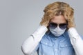 Virus Ideas. Concept of Coronavirus of Depressed Caucasian Woman In Glasses Touching Hair. Wearing Flu Virus Mask For Viral Royalty Free Stock Photo