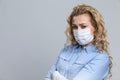 Virus Ideas. Concept of Coronavirus of Depressed Caucasian Woman Wearing Flu Virus Mask For Viral Prevention. Against Gray Royalty Free Stock Photo