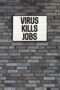 Virus Kills Jobs words in light box letters, corona virus pandemic buzwword headline