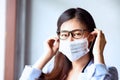 Virus mask Asian woman wearing face protection in office