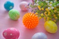 Virus model of Coronavirus disease COVID-19 with colorful easter eggs with flowers on a pink wooden table background Royalty Free Stock Photo