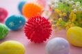 Virus model of Coronavirus disease COVID-19 with colorful easter eggs with flowers on a pink wooden table background Royalty Free Stock Photo