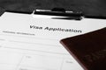 Visa application form for immigration and passport on grey table, closeup Royalty Free Stock Photo