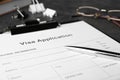 Visa application form for immigration and pen on grey table, closeup Royalty Free Stock Photo