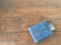 Visa card in blue jeans wallet on brown wooden table. Royalty Free Stock Photo