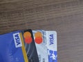 Visa card and mastercard cards over wooden background, elektonoc plastic card. Batam, Indonesia - March, 30, 2023