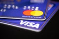 Visa and Mastercard credit cards close up shot on a black surface table Royalty Free Stock Photo