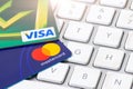 VISA and MASTERCARD credit cards supported on a computer keyboard Royalty Free Stock Photo