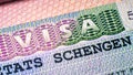 Visa stamp in passport closeup. European visitor visa at border control. Macro view of Schengen visa for tourism and travel in EU