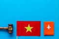 Visa to Vietnam concept. Vietnamese flag near passport and judge hammer on blue background top-down copy space Royalty Free Stock Photo