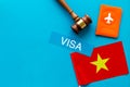 Visa to Vietnam concept. Vietnamese flag near passport and judge hammer on blue background top-down copy space Royalty Free Stock Photo