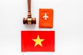 Visa to Vietnam concept. Vietnamese flag near passport and judge hammer on white background top-down Royalty Free Stock Photo