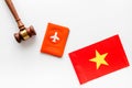 Visa to Vietnam concept. Vietnamese flag near passport and judge hammer on white background top-down copy space Royalty Free Stock Photo